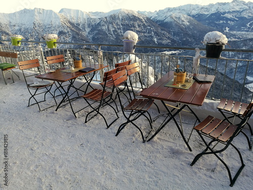 Bistrotische und Stühle auf der Besucherterrasse auf dem Gipfel des Laber mit viel Schnee und Alpenpanorama in Oberammergau bei Garmisch-Partenkirchen im Winter in Oberbayern im Winter photo