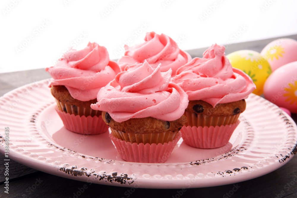 Tasty cupcakes on wooden background. Birthday cupcake in pink color