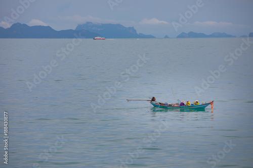 Fishermans in fishing boat in the blue sea, Thailand