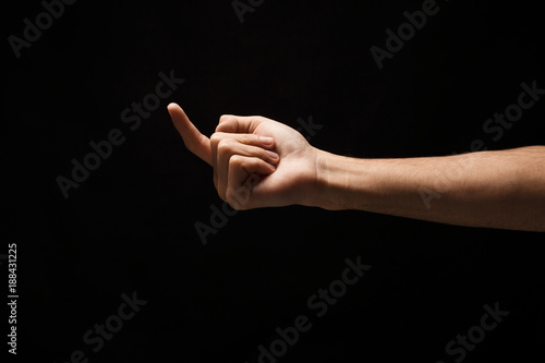 Male hand beckoning isolated on black background