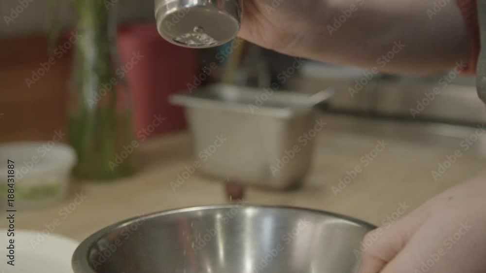 Slow motion, baker adds powdered sugar on fried dough Slow motion, baker adds powdered sugar on fried dough