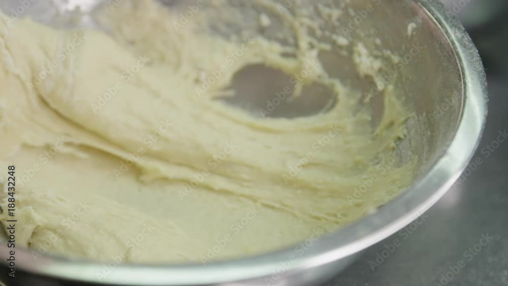Slow motion close up, baker makes spaetzle dough Slow motion close up, baker makes spaetzle dough