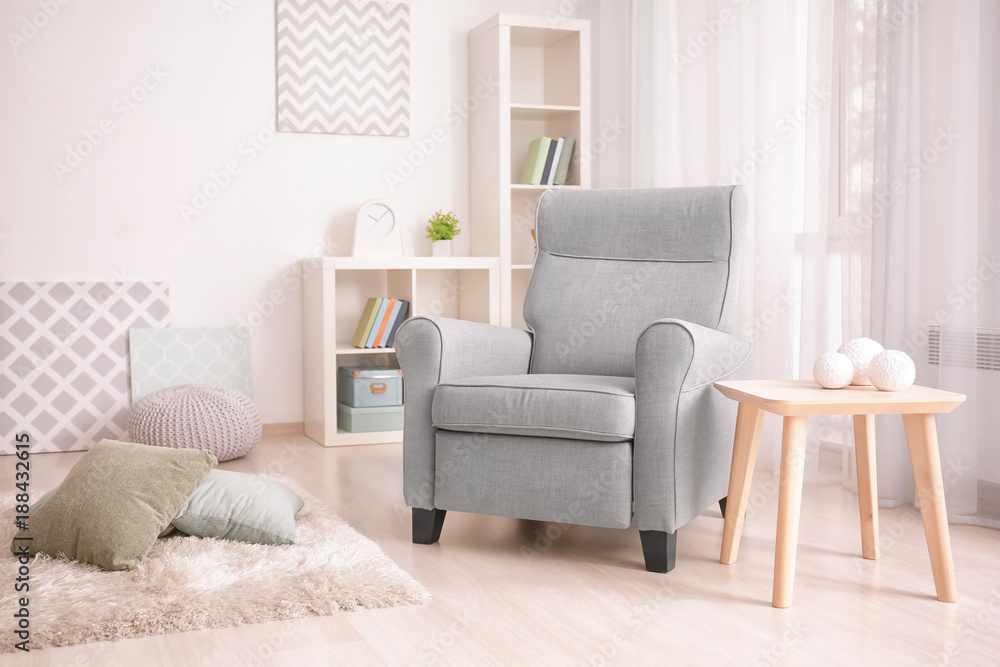 Obraz premium Elegant living room interior with comfortable armchair