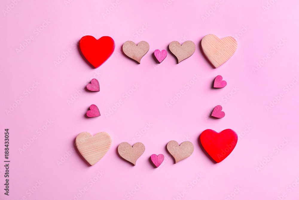 Frame made of hearts on color background