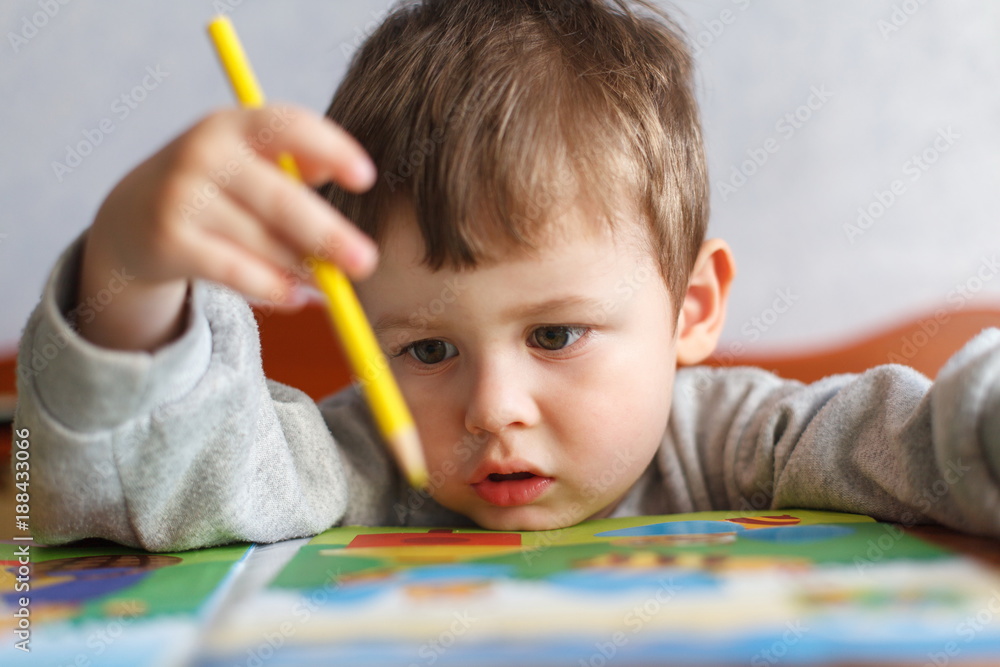 Kid boy drawing with color pencils Kid boy drawing with color pencils