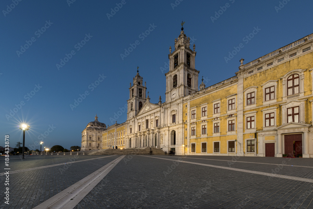 View of the Convent of Mafra at night in Mafra, Portugal; Concept for travel in Portugal and most beautiful places in Portugal