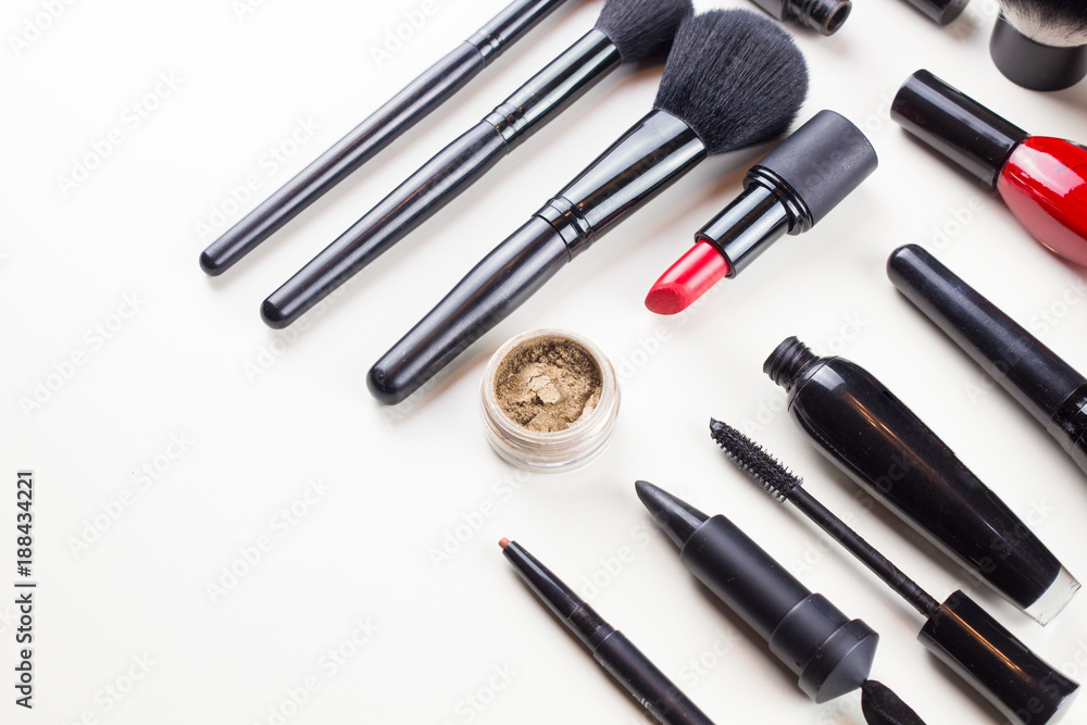Makeup set of cosmetics with brushes, powder and lipstick is isolated on a white Makeup set of cosmetics with brushes, powder and lipstick is isolated on a white