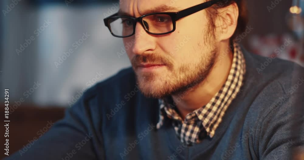 Close up view of angry businessman having problems with his device, clicking over and over again, checks the result, putts of the glasses and disappointed closes the laptop. Stress, troubles. Close up view of angry businessman having problems with his device, clicking over and over again, checks the result, putts of the glasses and disappointed closes the laptop. Stress, troubles.