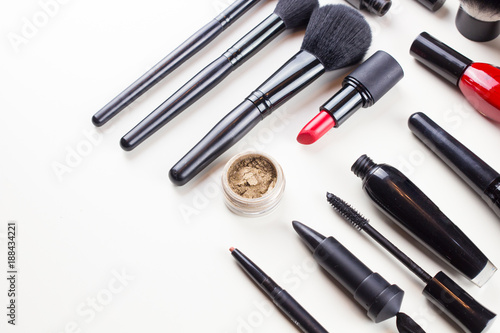 Makeup set of cosmetics with brushes, powder and lipstick is isolated on a white