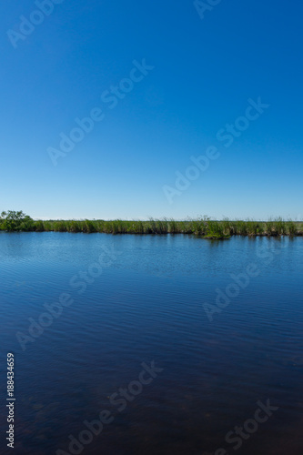 USA, Florida, Everglades river landscape with green sawgrass area behind