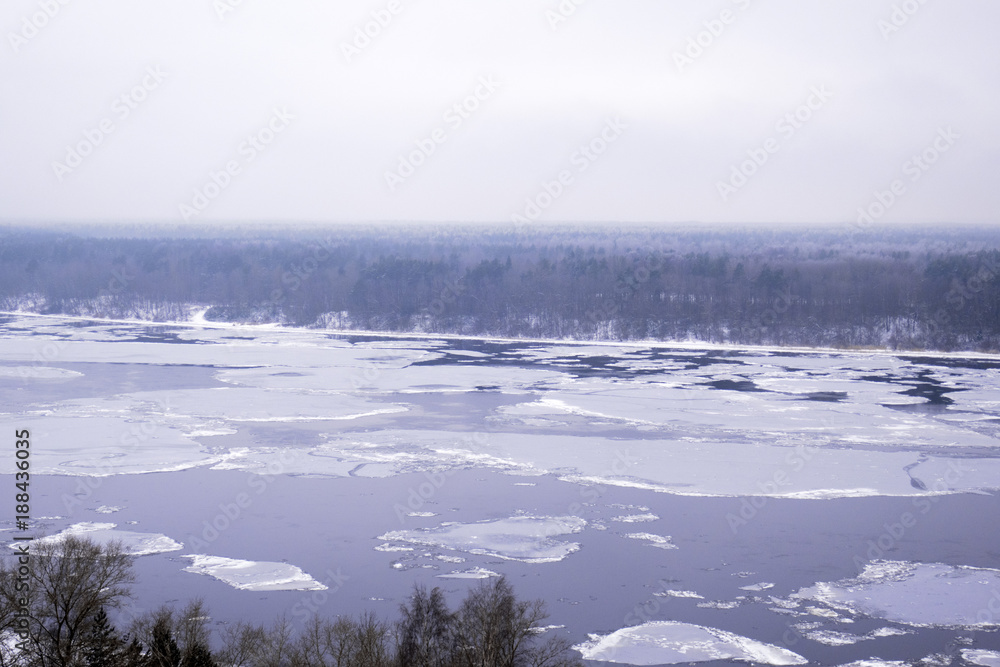 Beautiful nature, forest and ice on the wide Neva river in winter in Russia.