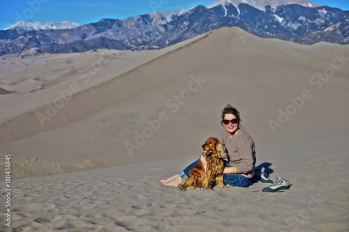 Young woman and her dog in Great Sand Dunes, Colorado photo