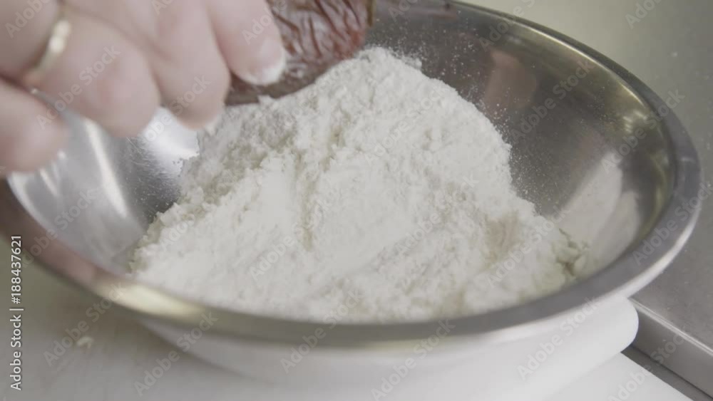 Close up, chef covers pepper in flour Close up, chef covers pepper in flour