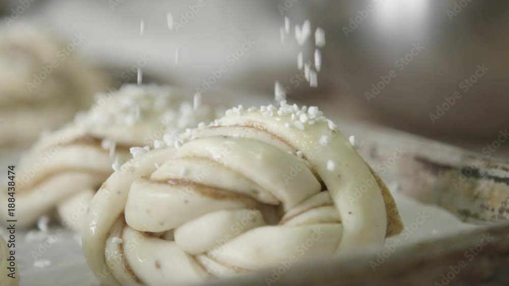 Salt sprinkled on dough, slow motion close up Salt sprinkled on dough, slow motion close up