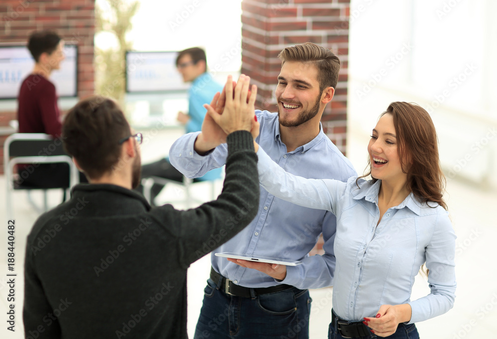 Happy business team using tablet in office. Happy business team using tablet in office.