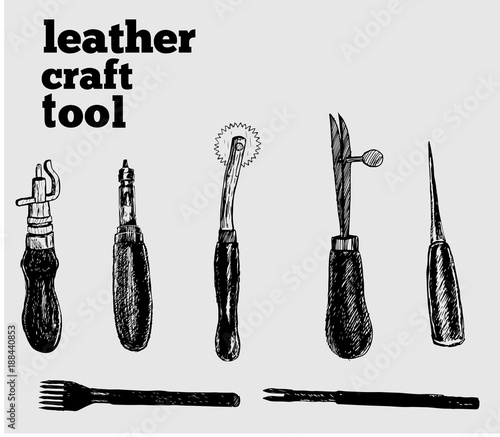 Leather craft tools and utensils on a white wooden background