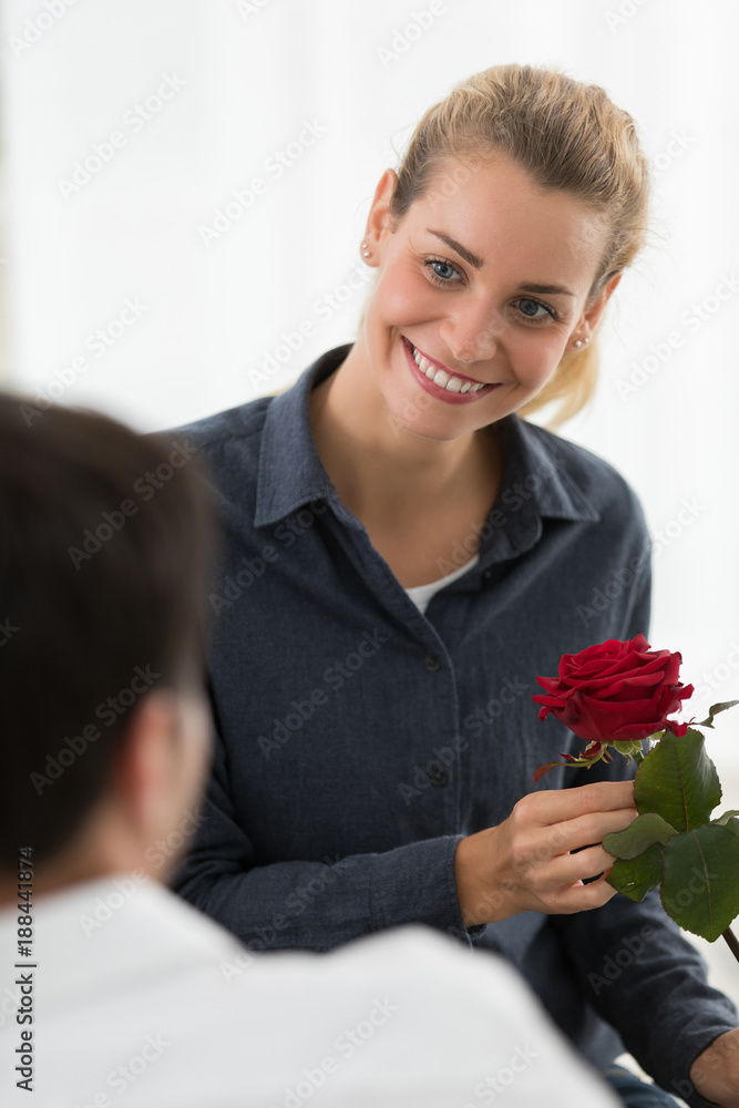 Valentine's day. Young beautiful woman receives a from her handsome boyfriend Valentine's day. Young beautiful woman receives a from her handsome boyfriend