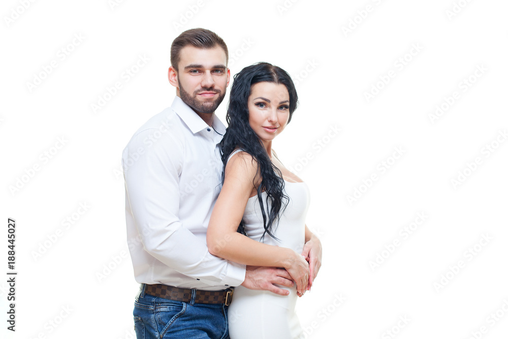 Portrait of beautiful smiling couple posing at studio over white background. valentines day theme