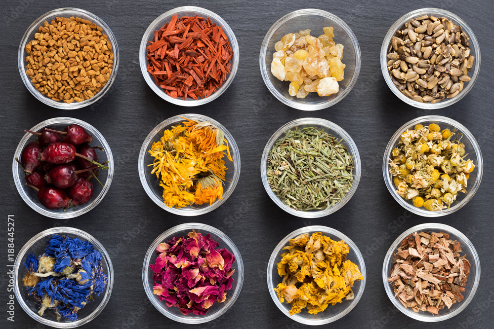 Selection of dried herbs on a dark background, top view