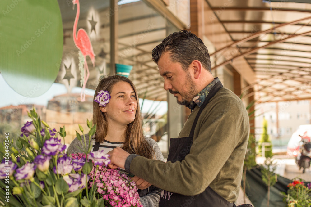 Florist couple working in a flower shop Florist couple working in a flower shop