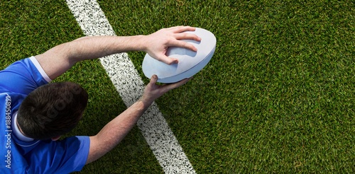 Composite image of a rugby player scoring a try photo