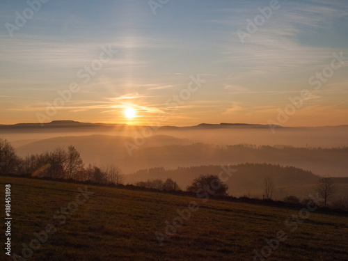 Fototapeta Naklejka Na Ścianę i Meble -  View of the setting sun in the Sudety Mountains 
