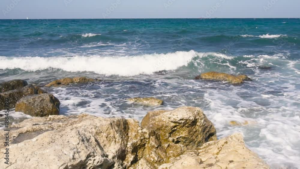 Wide still shot of waves breaking on a rocky Wide still shot of waves breaking on a rocky