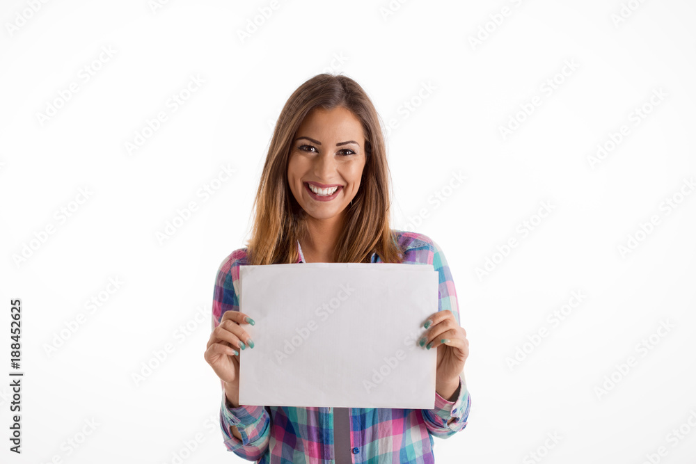 Beautiful girl holding a white sign while smiling at the camera Beautiful girl holding a white sign while smiling at the camera