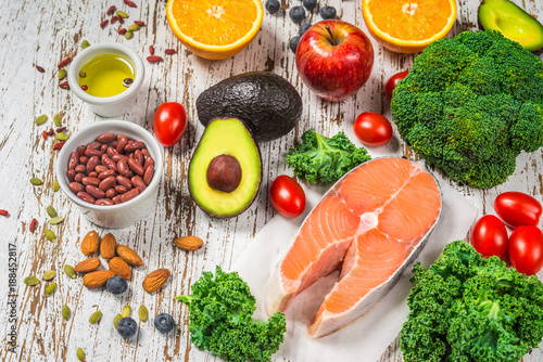 Selection of fresh fruit and vegetables, salmon, beans, and nuts. Concept of cooking and eating healthy food, fitness, dieting, vegetarian, and lifestyle. Ingredients good for heart and diabetes.
