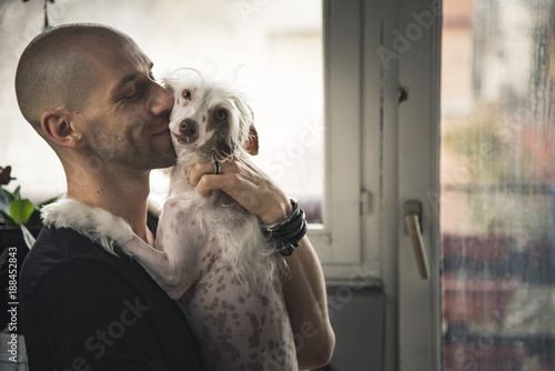 Photos Young man and his dog enjoying each other's company, man affectionately hugging
