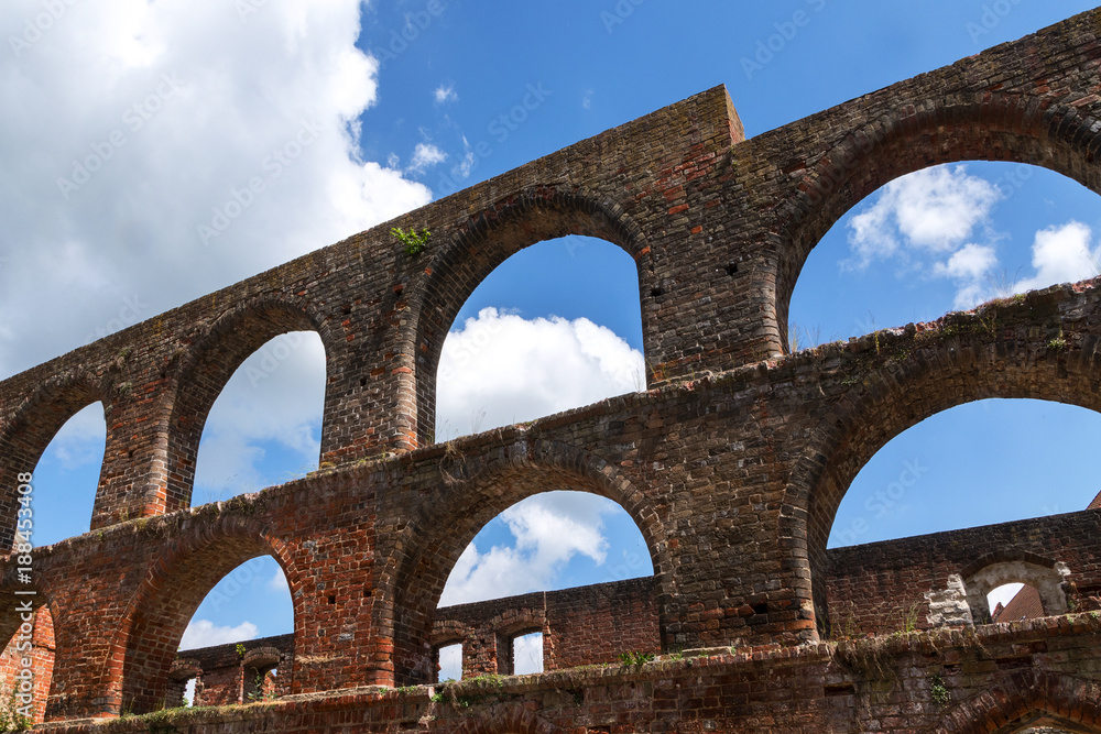 window arches in the monastery ruin from brick masonry in Bad Doberan, northern Germany, blue sky with clouds
