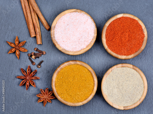 Group of spices in a bowls on slate