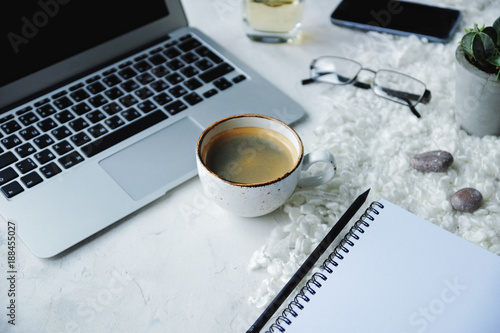 laptop computer, coffee mug, notebook and smart phone on white background