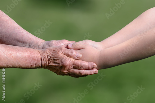 Old and young holding hands © Vaceslav Romanov