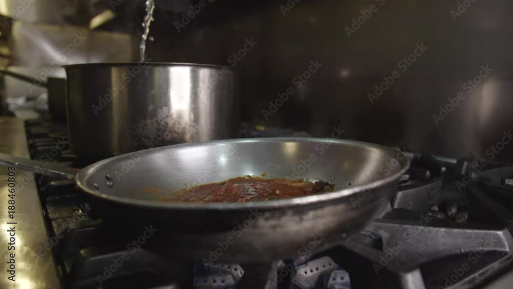 Close up, chef pours pasta in sauce pan Close up, chef pours pasta in sauce pan
