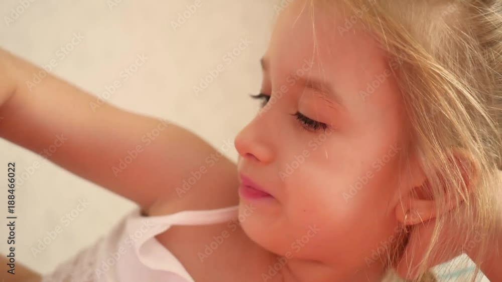 Young girl indoors eating chips smiling. Eating harmful food. Young girl indoors eating chips smiling. Eating harmful food.