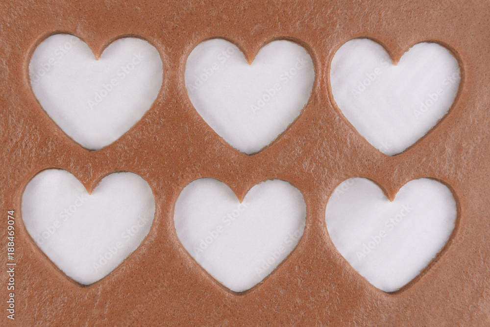 Six heart shapes cut out of dough