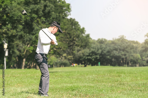 Asian men playing golf. men play golf while standing on field
