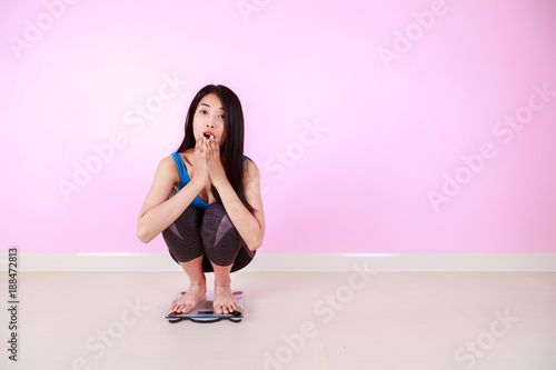 shocked woman sitting on a weight scale