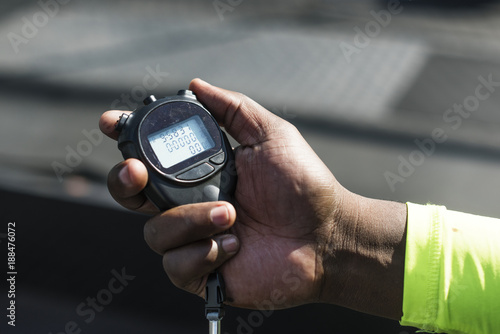 Closeup of hand holding stopwatch photo