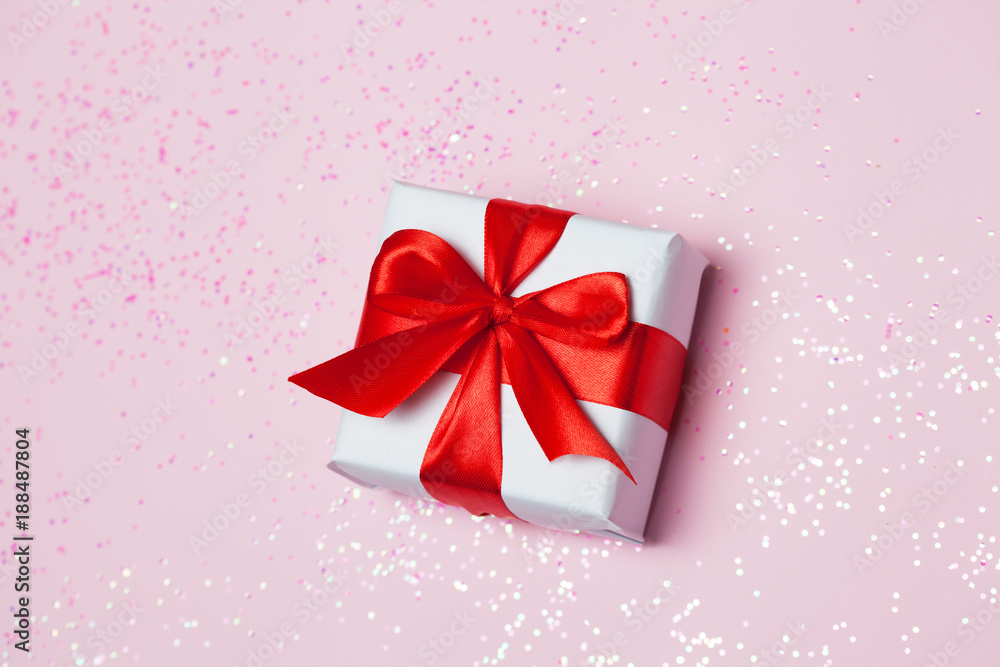 gift box vith red bow and glitter sparkles on pink background. st. Valentine's day concept gift box vith red bow and glitter sparkles on pink background. st. Valentine's day concept