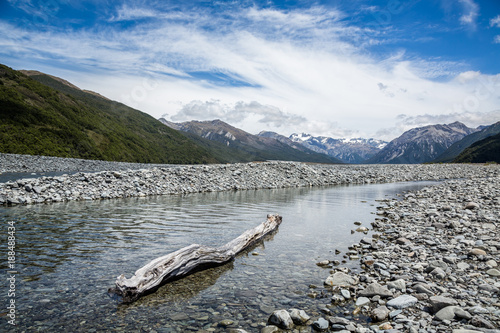 Driftwood log in braided river of New Zealand photo