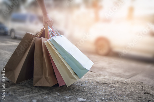Woman hands with bags after shopping, discount shopping concept