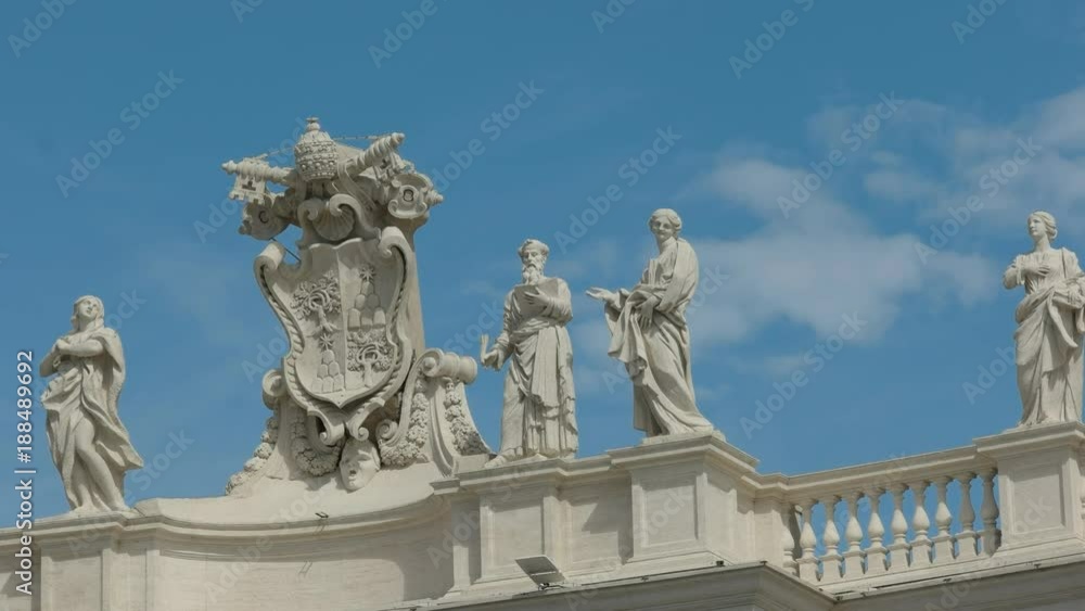 close up of a papal crest and statues in st peter's square vatican city close up of a papal crest and statues in st peter's square vatican city