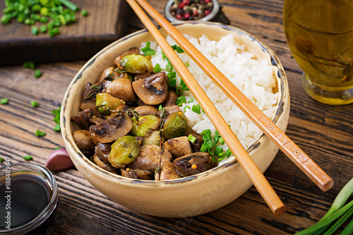 Vegan menu. Dietary food. Boiled rice with mushrooms and Brussels sprouts in Asian style.