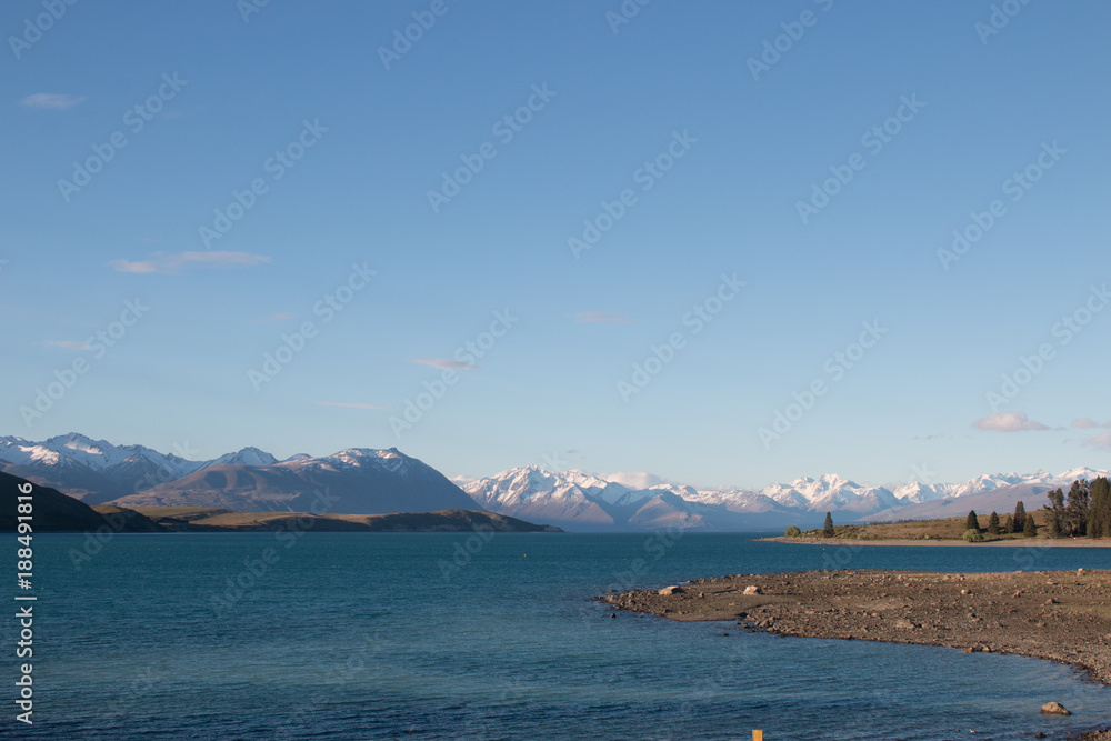 New Zealand Lake Tekapo blue lake with snow mountain panorama blue sky