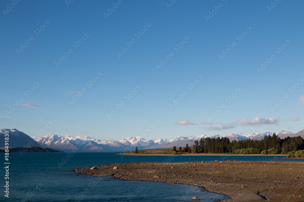 New Zealand Lake Tekapo blue lake with snow mountain range
