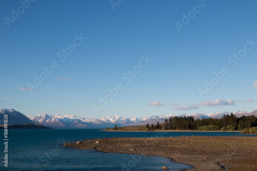 New Zealand Lake Tekapo blue lake with snow mountain range