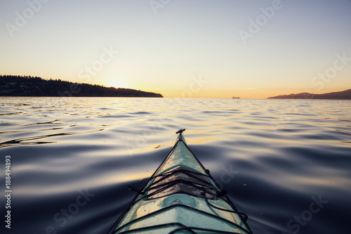 Kayaking during a vibrant Sunset. Taken in Jericho Beach, Vancouver, British Columbia, Canada.