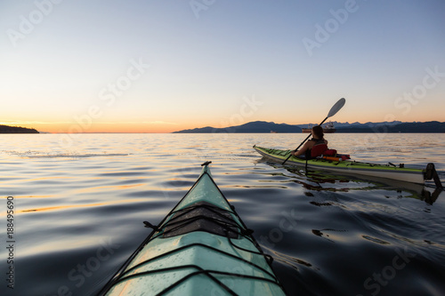 Adventure Girl kayaking on a sea kayak during a colorful and vibrant sunset. Taken near Jericho Beach, Vancouver, © edb3_16